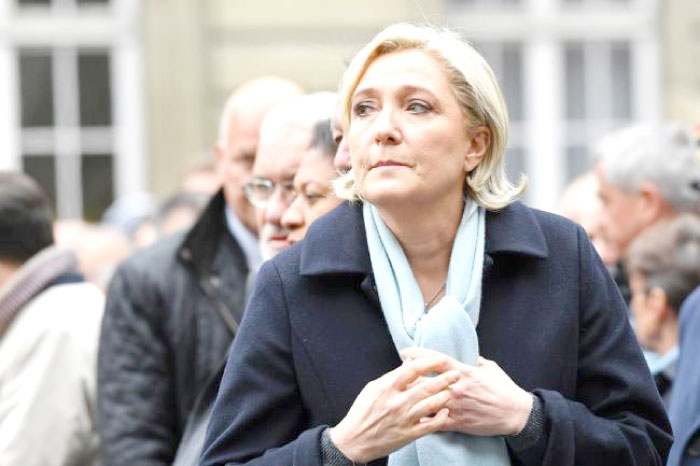 French presidential election candidate for the far-right Front National (FN) party, Marine Le Pen attends a ceremony honouring the policeman killed by a militant in an attack on the Champs Elysees, at the Paris prefecture building on Tuesday. — AFP