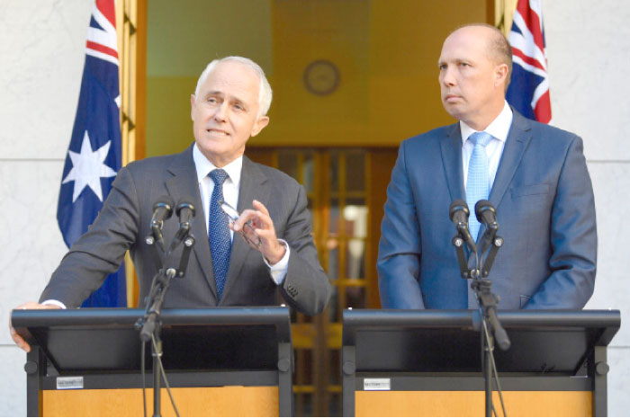Australia’s Prime Minister Malcolm Turnbull speaks as Immigration Minister Peter Dutton listens on during a media conference at Parliament House in Canberra, Australia, on Tuesday. — Reuters