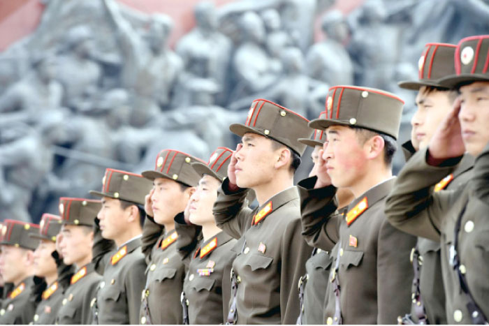 North Korean soldiers salute bronze statues, not pictured, of North Korea’s late founder Kim Il-sung and late leader Kim Jong Il at Mansudae in Pyongyang on Tuesday to mark the 85th anniversary of the founding of the Korean People’s Army. — Reuters