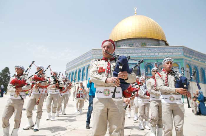 Palestinian scouts perform outside the Al-Aqsa mosque compound in occupied Jerusalem on Saturday. — AFP