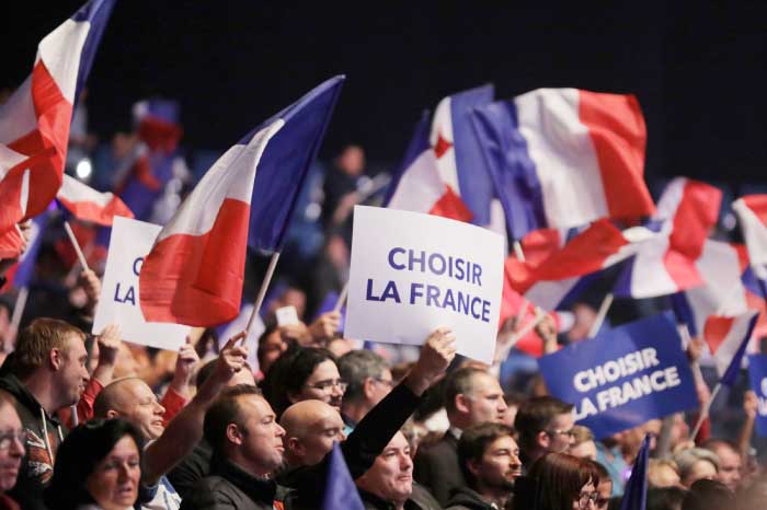Supporters for Marine Le Pen hold a placard with the slogan, “Choose France” as they attend a campaign rally in Nice. — Reuters