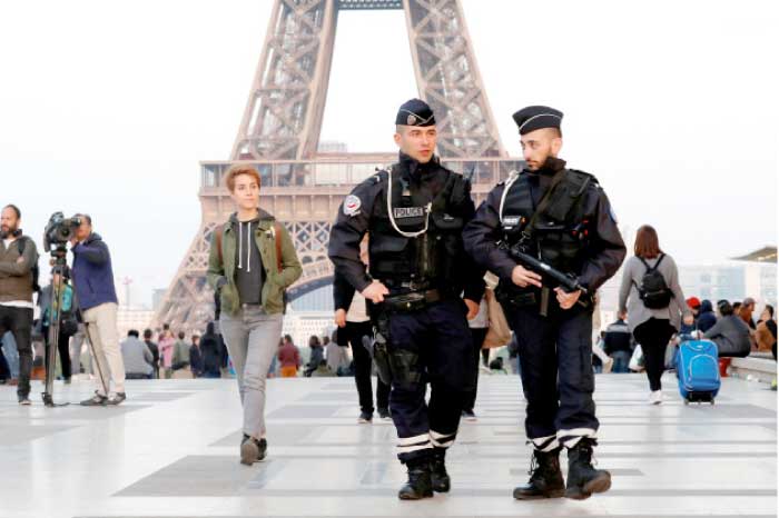 Police patrol at the Trocadero near the Eiffel Tower after a policeman was killed and two others were wounded in a shooting incident in Paris, France, on Friday. — Reuters