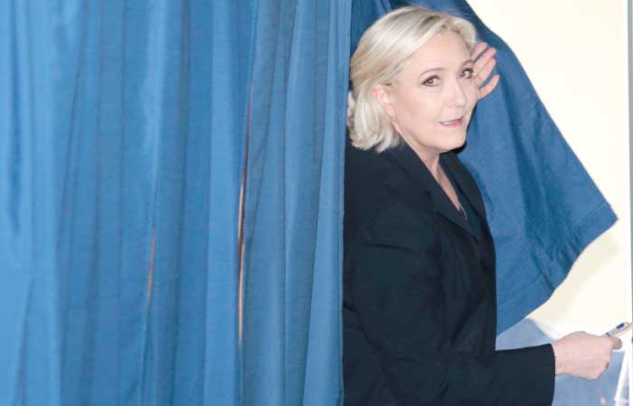 French presidential election candidate for the far-right Front National party Marine Le Pen leaves a polling booth to vote at a polling station in Henin-Beaumont, north-western France, on Sunday, during the first round of the presidential election. — AFP