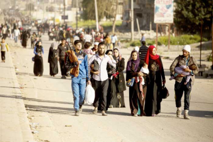 Civilians flee via the main road in Mosul as Iraqi special forces battle Daesh militants. — AP