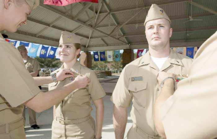 In this Dec. 5, 2012, file photo, released by the US Navy, Lt j.g. Marquette Leveque, left, and Lt. j.g. Kyle McFadden, both of the USS Wyoming, receive their pins to indicate that they’re qualified to serve on submarines in a ceremony at Naval Submarine Base Kings Bay in Georgia. — AP