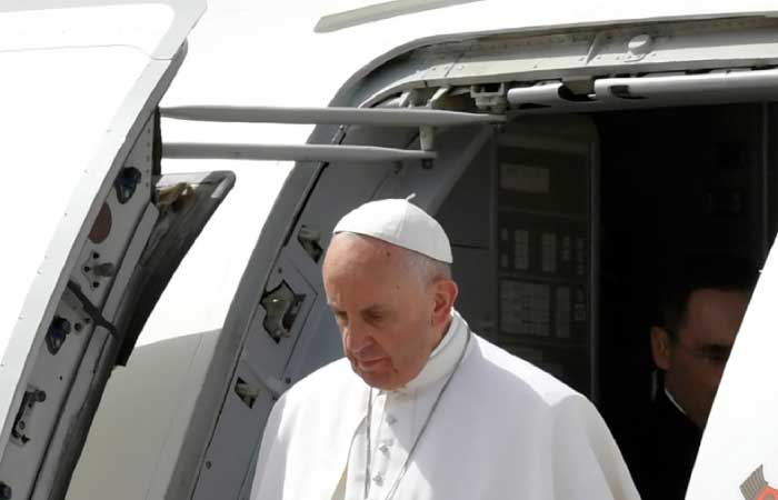 Pope Francis disembarks from his plane upon his arrival at Cairo’s International Airport, Friday. — AFP