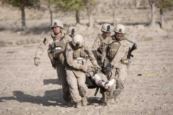 US Marines carry a wounded colleague, who was hit by an Improvised Explosive Device (IED), to a medevac helicopter of US Army’s Task Force Lift “Dust Off,” Charlie Company 1-171 Aviation Regiment, to be airlifted in Helmand province, in this Oct. 31, 2011 file photo. — AFP