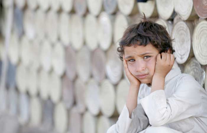 A boy looks on as he sits next to a hut at a camp for people displaced by the war in Yemen caused by Houthi rebels and militias loyal to ousted president Ali Abdullah Saleh. — Reuters