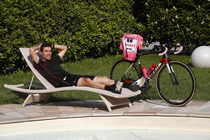 Pink Jersey Tom Dumoulin of Netherlands (team Sunweb) poses by the pool after a press conference on Monday in Boario Terme, during a rest day of the 100th Giro d'Italia, Tour of Italy, cycling race. — AFP