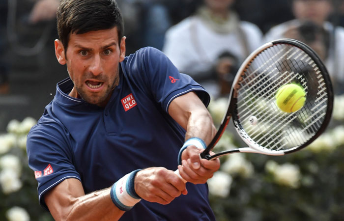 Serbia's Novak Djokovic returns the ball to Britain's Aljaz Bedene during their tennis match at the ATP Tennis Open tournament on Tuesday at the Foro Italico in Rome. — AFP