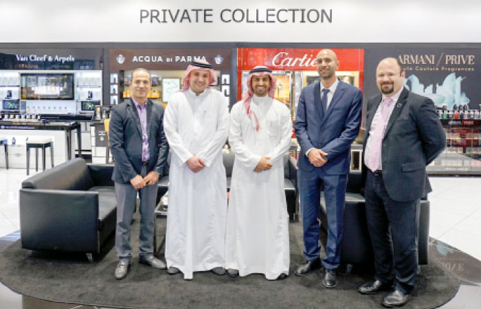 Faisal Binzarah, Director Loyalty Programs at Mobily, and Mutasem Jamjoum, Marketing Director at Wojooh centers, pose with other executives during the announcement