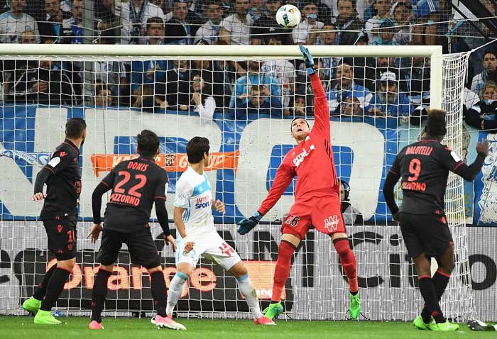 Olympique de Marseille's French goalkeeper Yohann Pele (2nd R) stops the ball during the French L1 football match against Nice at the Velodrome stadium in Marseille, on Sunday. — AFP