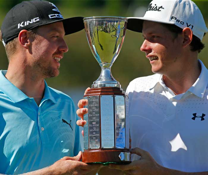 Jonas Blixt, of Sweden, left, and teammate Cameron Smith, of Australia, hold up their tournament trophy after they won a sudden-death playoff for the PGA Zurich Classic golf tournament's new two-man team format at TPC Louisiana in Avondale, La., Monday.  — AP