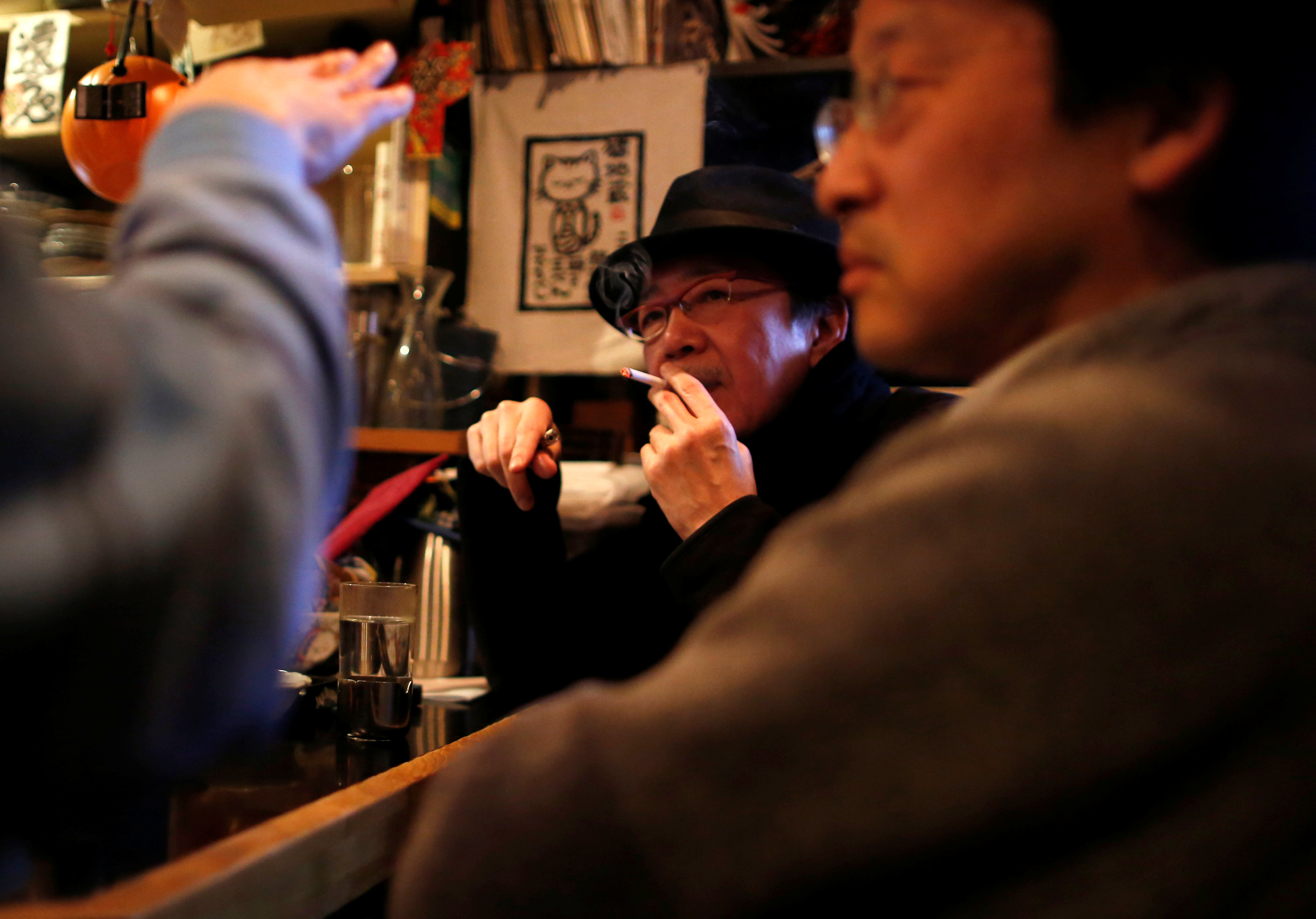 A man smokes at an 'izakaya' restaurant or pub in Tokyo, Japan in this file photo. — Reuters