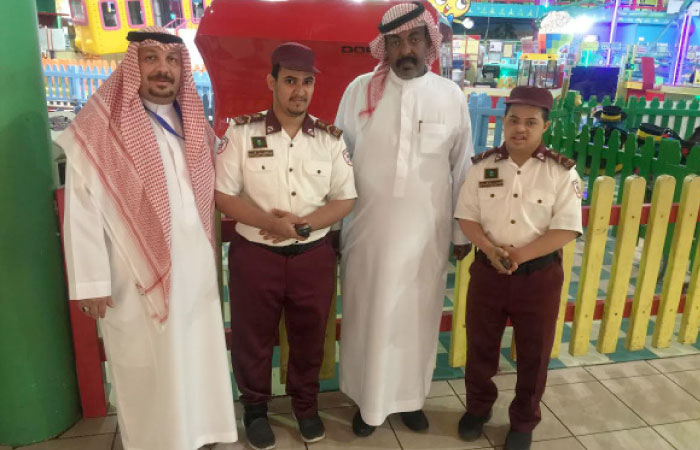 Marwan Bahrawi, the manager of Dhiyafa Mall, with some of the trainees and their supervisor. — SG photo