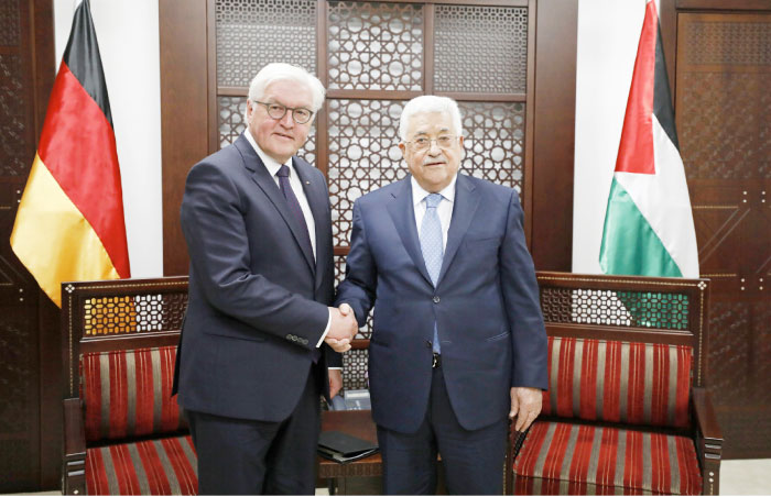 Palestinian President Mahmoud Abbas (R), shakes hands with German President Frank-Walter Steinmeier during their meeting in the West Bank city of Ramallah – AP