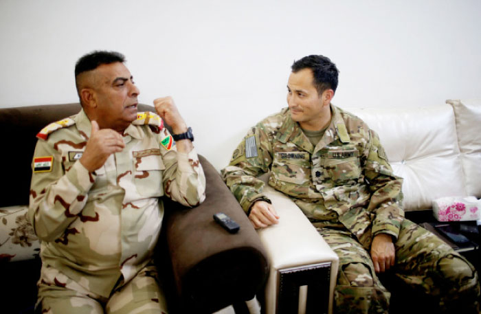 U.S. Army Lieutenant Colonel James Browning (R), the partnered advisor to the Iraqi 9th Armoured Division and commander of Taskforce Fury, listens to Lieutenant General Qassem al-Maliki, commander of the Iraqi army’s Ninth Armoured Division at a military base southwest of Mosul.  – Reuters