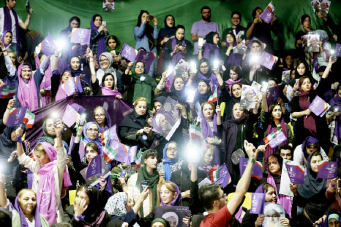 Supporters of Iranian President Hassan Rohani for May 19 presidential election attend a campaign rally in Tehran, Tuesday. Rohani faces off against five challengers. — AP