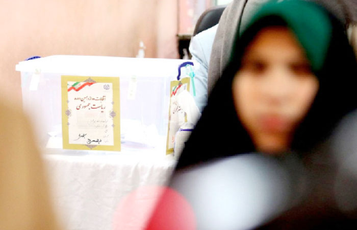 An Iranian woman leaves the room after casting her ballot during Iran’s 12th presidential election earlier this month. — AFP