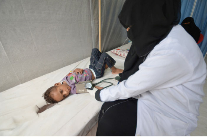 A nurse attends to a boy infected with cholera at a hospital in the Red Sea port city of Hodeidah –  Reuters