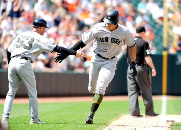 New York Yankees outfielder Aaron Judge (99) high fives third base coach Joe Espada (53) after hitting a home run in the seventh inning against the Baltimore Orioles at Oriole Park at Camden Yards. — Reuters