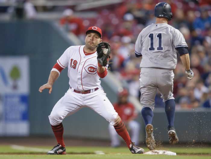 Joey Votto of the Cincinnati Reds catches the ball for the out at first as Brett Gardner of the New York Yankees runs to the bag during their MLB game at Great American Ball Park in Cincinnati Tuesday. — AFP