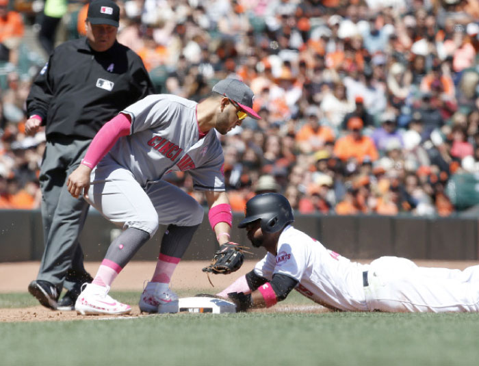 San Francisco Giants' Eduardo Nunez (10) slides into third base in front of Cincinnati Reds third baseman Eugenio Suarez (7) tag during the fifth inning of a baseball game in San Francisco, Sunday. —AP