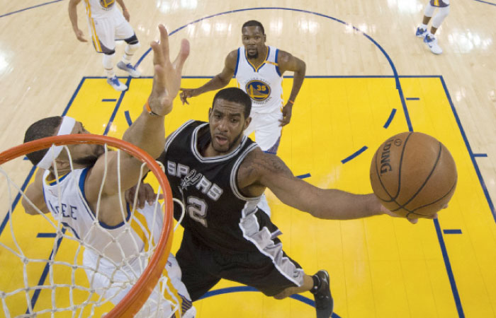 San Antonio Spurs forward LaMarcus Aldridge (12) shoots the basketball against Golden State Warriors center JaVale McGee (1) during the first half in game one of the Western conference finals of the NBA Playoffs at Oracle Arena. The Warriors defeated the Spurs 113-111. — Reuters