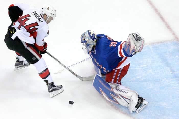 New York Rangers’ goalie Henrik Lundqvist (R) makes a save against Ottawa Senators center Jean-Gabriel Pageau during their Stanley Cup Playoffs at Madison Square Garden in New York Thursday. — Reuters