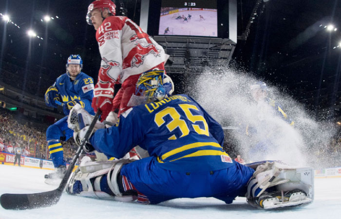 Sweden's goal tender Henrik Lundqvist saves a shot by Denmark's Mikkel Aagaard in the IIHF World Championships Group A clash in COlogne, Germany, on Sunday. — Reuters