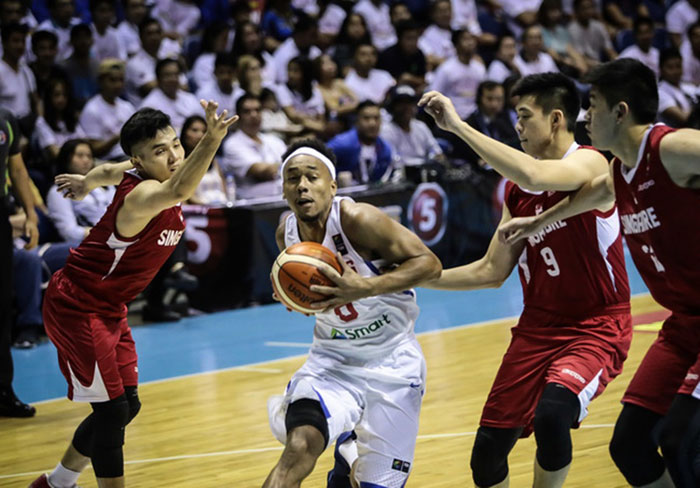 Gilas Pilipinas' Calvin Abueva bulldozes his way to the basket past three Singaporean defenders in the 2017 SEABA Championship at the Smart-Araneta Coliseum in Manila Saturday night.