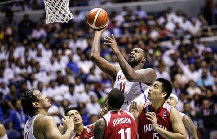 Gilas Pilipinas' Andray Blatche towers over three Indonesian defenders as he goes for an easy bucket in the final game of the 2017 SEABA Championship at the Smart-Araneta Coliseum Thursday night.