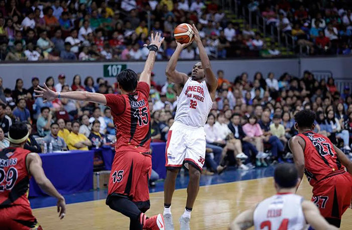 Barangay Ginebra's Justin Brownlee fires a fade-away jumper off San Miguel Beer's June Mar Fajardo in their PBA Commissioner's Cup game at the Mall of Asia Arena Sunday night.