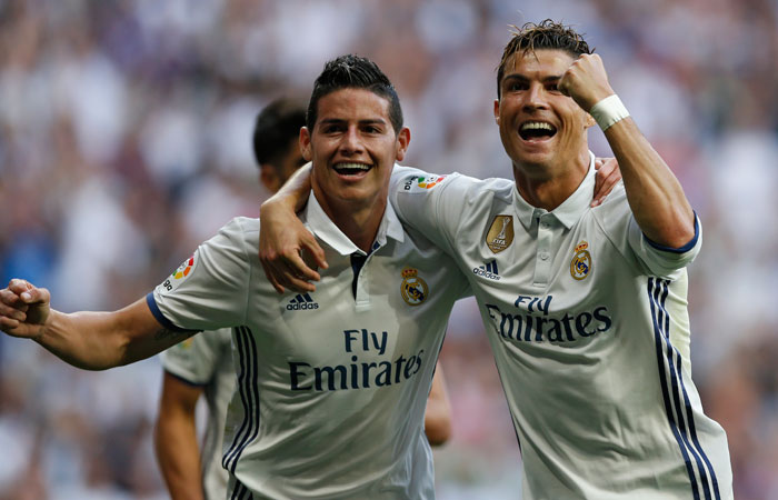 Real Madrid's Cristiano Ronaldo, right, celebrates with teammate James Rodriguez after scoring their side's second goal against Sevilla during the La Liga match between Real Madrid and Sevilla at the Santiago Bernabeu stadium in Madrid, Sunday. Ronaldo scored twice in Real Madrid's 4-1 victory. —AP