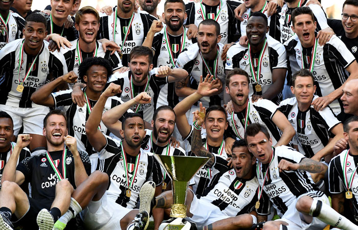 Juventus players pose for a team photo after emerging champions at Juventus Stadium in Turin Sunday. — Reuters