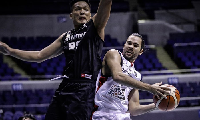 Thailand's Wutipong Dasom bangs bodies with a Myanmar defender in the 2017 SEABA Championship in Manila on Monday.