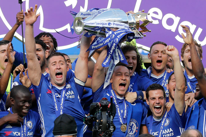 Chelsea captain John Terry and Gary Cahill raise the trophy after they won the English Premier League at Stamford Bridge Stadium in London Sunday. — AP