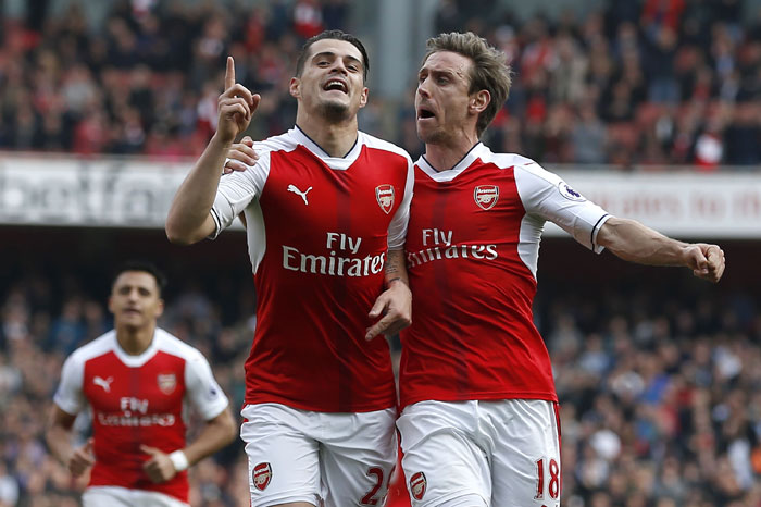 Arsenal's midfielder Granit Xhaka celebrates with defender Nacho Monreal (R) after scoring the opening goal of the English Premier League football match against Manchester United at the Emirates Stadium in London Sunday. — AFP