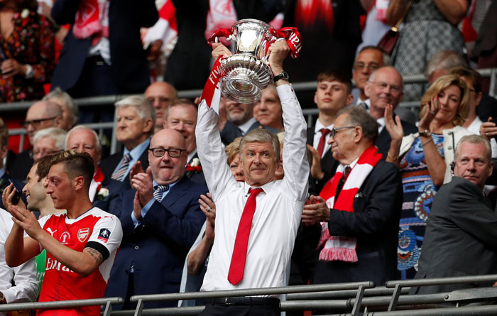Arsenal manager Arsene Wenger celebrates by lifting the trophy after the FA Cup final at Wembley Stadium Saturday. — Reuters