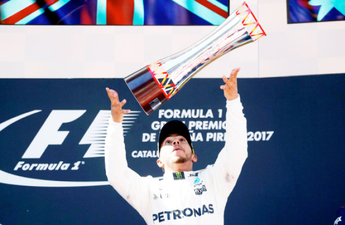 Mercedes’ Lewis Hamilton celebrates on the podium of the Spanish Grand Prix at the Barcelona-Catalunya racetrack Sunday. — Reuters