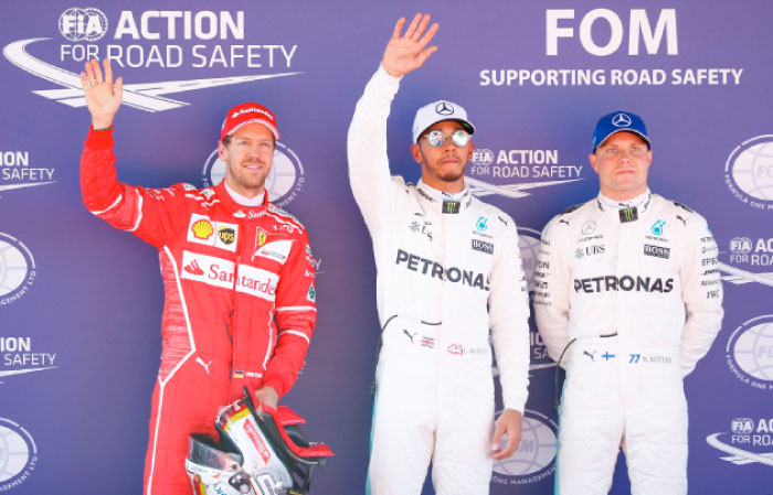 (From L) Ferrari’s Sebastian Vettel, Mercedes’ Lewis Hamilton and Mercedes’ Valtteri Bottas wave after the qualifying session of the Spanish Grand Prix at the Barcelona-Catalunya racetrack Saturday. — Reuters