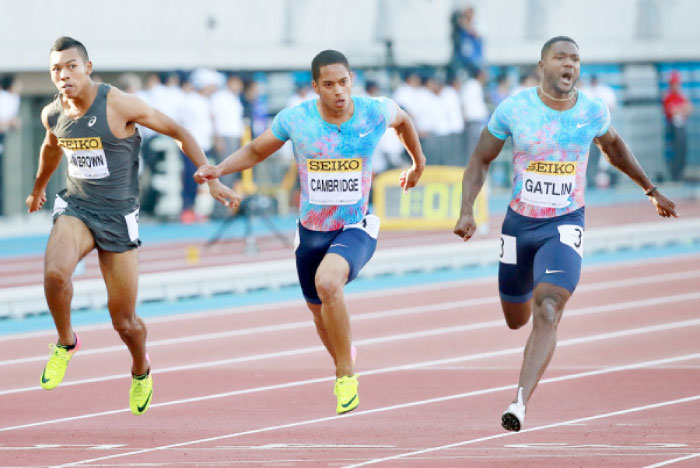 Justin Gatlin (R) of the US competes ahead of Aska Cambridge (C) and Abdul Hakim Sani Brown of Japan in the men’s 100 meters at the Golden Grand Prix Track and Field Meet in Kawasaki Sunday. — AP