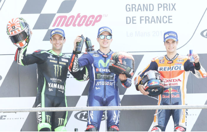 MotoGP rider Maverick Vinales (C) of Spain, celebrates his first position next to second placed Johann Zarco (L) of France and third placed Dani Pedrosa of Spain on the podium of the French Grand Prix in Le Mans Sunday. — AP