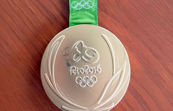 This photo provided by Kevin Snyder show her damaged gold medal from the 2016 Rio Olympics Tuesday, May 23, 2017, in Maryland. — AP