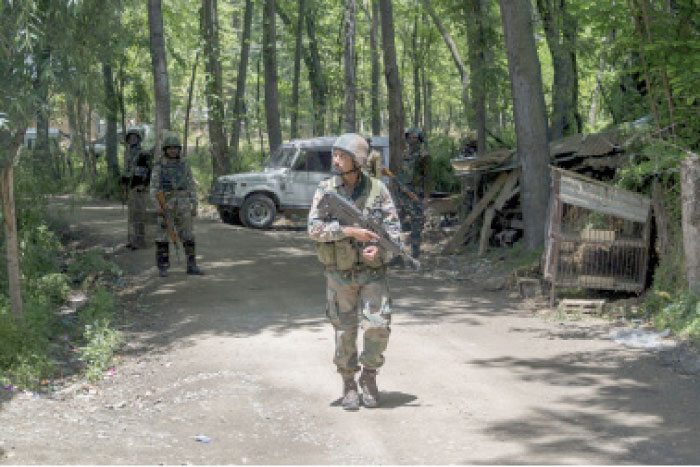 Indian army soldiers patrol near the site of a gun battle at Saimoh village, in Tral area, about 45 km south of Srinagar, Indian controlled Kashmir, on Saturday. — AP