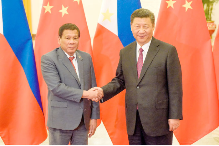 Chinese President Xi Jinping, right, shakes hands with Philippines President Rodrigo Duterte prior to their bilateral meeting during the Belt and Road Forum, at the Great Hall of the People in Beijing on Monday. — Reuters