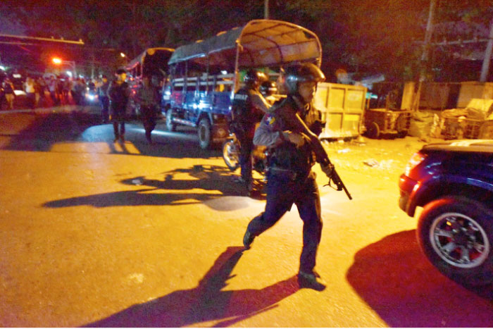 Myanmar riot police walk along a street in Yangon’s Mingalar Taung Nyunt township early on Wednesday, after scuffles broke out between Buddhist nationalists and Muslims. — AFP