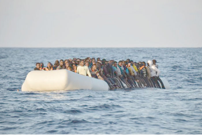 Migrants and refugees are on a rubber boat before to be rescued by the ship Topaz Responder run by Maltese NGO Moas and the Red Cross, off the Libyan coast in the Mediterranean Sea, in this file photo. — AFP