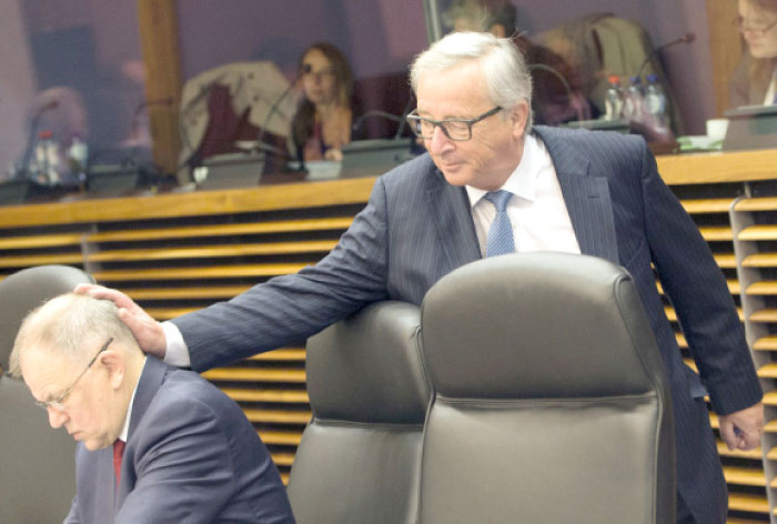 European Commission President Jean-Claude Juncker, right, touches the head of European Commissioner for Food Safety Vytenis Andriukaitis as he arrives for a weekly EU Commission meeting at EU headquarters in Brussels on Wednesday. — AP