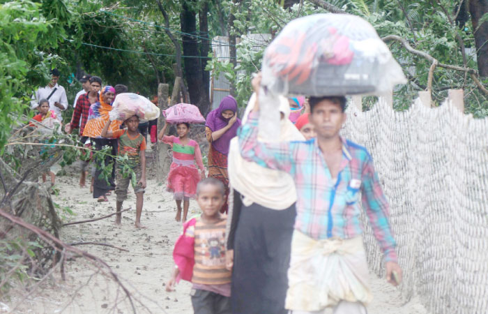 Bangladeshi villagers evacuate to cyclone shelters on the coast in Cox’s Bazar district on Tuesday. — AFP